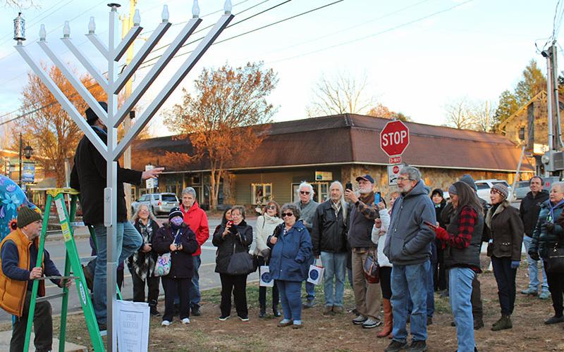 The Jewish Congregation of Blue Ridge met in front of the Daffodil Project Garden next to the park in downtown Blue Ridge where a public menorah was donated for the first night of Hanukkah Sunday, November 28. Each evening at sundown, the menorah’s electric candles will automatically light for each night of Hanukkah. There will be another gathering and lighting for the eighth and final night of Hanukkah Sunday, December 5, at 5 p.m.