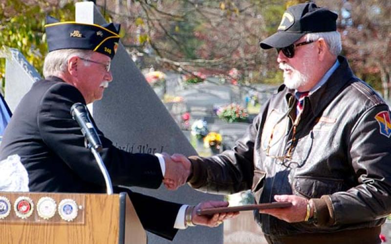 Veteran Bill Stodghill presents a plaque to fellow veteran Ben Arp, who was the keynote speaker during this year’s Veterans Day Ceremony at the Fannin County Veterans Memorial Park.
