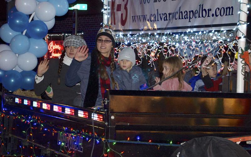 Folks from Calvary Chapel Christian School wave to the crowd along Mountain Street in Blue Ridge as they make their way along the Light Up Blue Ridge parade route Saturday, November 27.