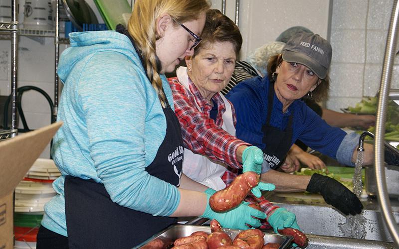Washing sweet potatoes in Fannin County High School’s (FCHS) kitchen for the Good Samaritans of Fannin County Thanksgiving Open Table are, from left, Cassie Corey, Priscilla Cashman and Kathy Beck. The Good Samaritans, with a host of volunteers, held the annual community meal. Thanksgiving Day in the FCHS cafeteria.