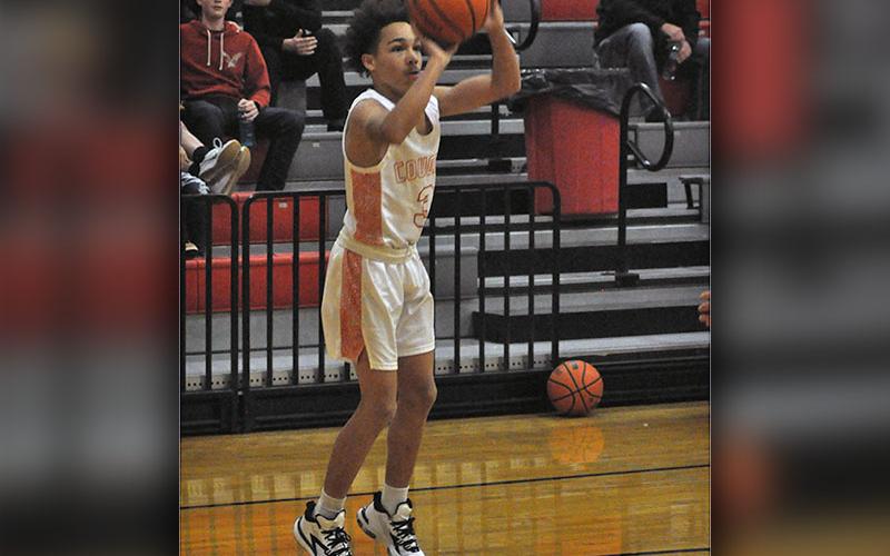 AJ Fitchett shoots a long range two-point basket during the Cougars game against the Bradley Knights Tuesday, December 14.