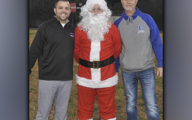 Santa was greeted by athletic coordinator Tim Towe, left, and Fannin Recreation Center Director Eddie O’Neal during the Winter Wonderland event held at the Fannin Coutny Recreation Center Friday, December 3. Santa was brought to the rec center by Blue Ridge Helicopter Tours for the second year in a row.