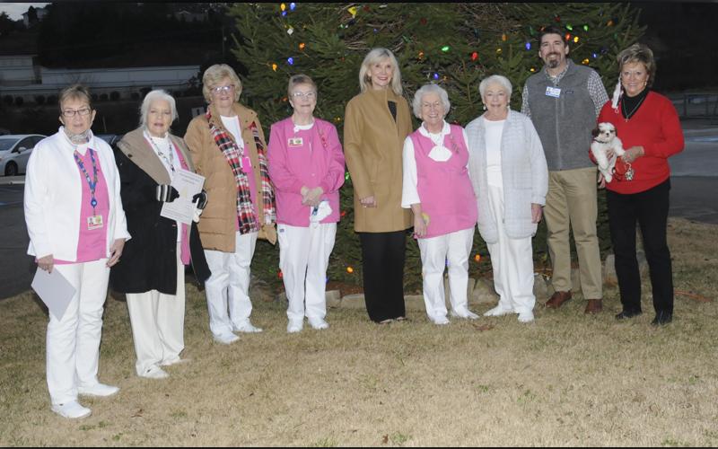 Braving the crisp weather, this group gathered to celebrate the Fannin Regional Hospital Auxiliary Love Light tree lighting December 7. From left are Jeane Bonnewitz, Joan Huddleston, Becky Guthrie, Barbara Cheatham, hospital Director of Volunteer Services Susan Kiker, Fannin Regional Hospital Auxiliary President Shirley Copeland, Laura Haight, Fannin Regional Hospital Chief Executive Officer Jason Jones, and Rita Oberle holding Sophie.