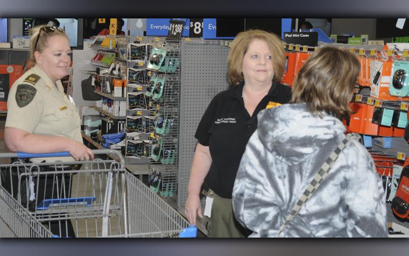 Captain Jill Huffman, left, and Dispatcher Melissa Stonecipher helped a young lady during Shop With a Cop Saturday morning at the Blue Ridge Walmart. A total of 80 youngsters benefited from this year’s program.