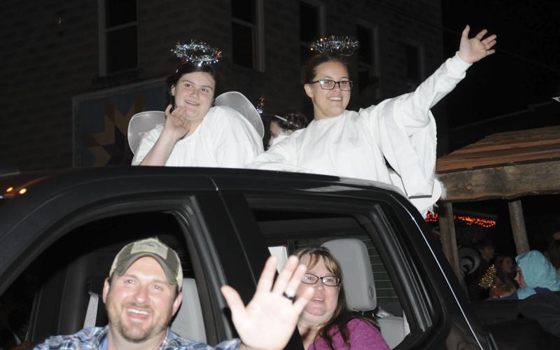 Angels Ella Nicholson, left, and Mary Beth Wells, along with Youth Director Chad Nicholson and Rachel Buller from Mine City Baptist Church, wave to the parade crowd in Ducktown.