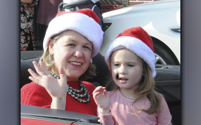 Copperhill Kiwanis Club Christmas Parade Grand Marshall Laura Crawford and a young friend wave to the crowd during the event Saturday, December 4. This marked the 62nd consecutive year for the annual parade.