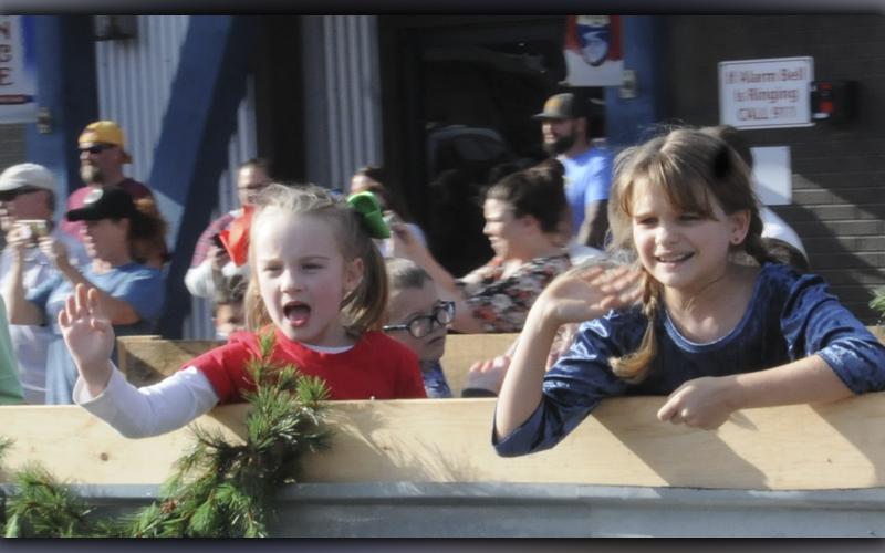 These youngsters help spread Christmas cheer as they throw out candy and yell “Merry Christmas” to a crowd along the streets in McCaysville and Copperhill.
