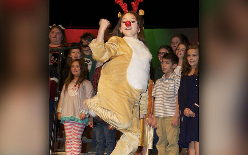 Rudolph the Red Nosed Reindeer, played by fifth grade student Morgan Nelson, made an appearance during the third grade performances and performed a hip hop number.