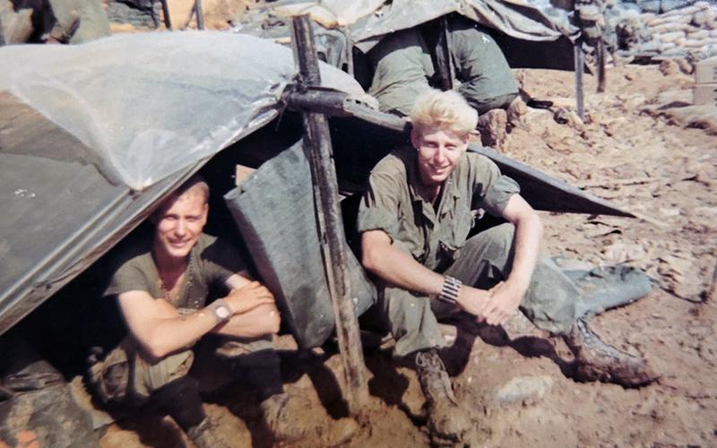 Floyd Ballance, right, is shown in between filling sand bags during his time overseas in the United States Army.
