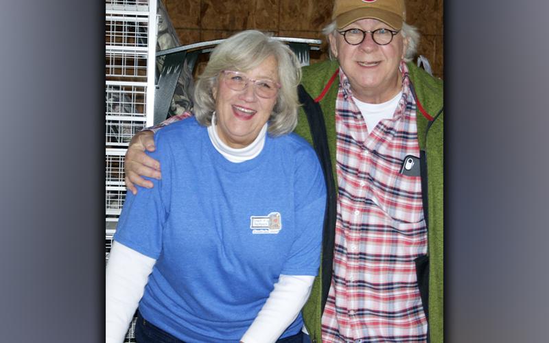 Snack in a Backpack Executive Director Debby Beck and volunteer Kirk Williams take a quick break from loading packs for a photo during packing day.