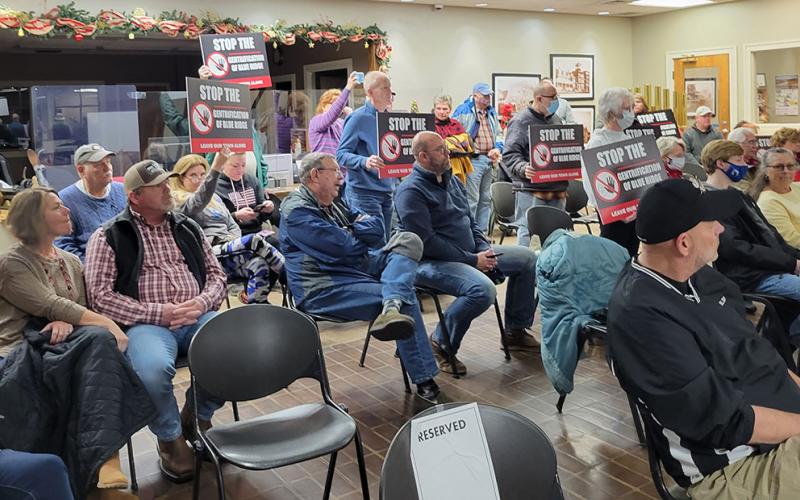 Around 10 individuals who attended the City of Blue Ridge’s Tuesday, December 21, council meeting held up these signs, showing their opposition to the proposed 60-foot condominium development on West First Street. The signs read, “Stop the gentrification of Blue Ridge. Leave our town alone.”