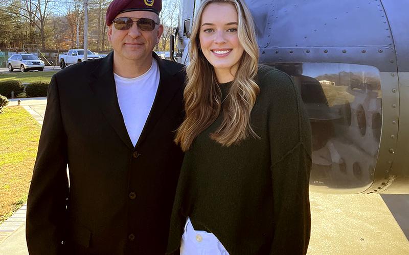 Sydney Petty is shown with Denton Petty in front of the Huey helicopter at the Veterans Memorial Park in Blue Ridge.