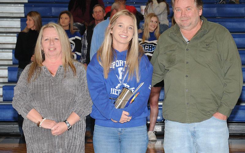 Emily Turner is shown with her parents, Buffy and Eric Turner, during Senior Night at Fannin County High School Friday, January 7. A trainer for all the sports at FCHS, she has been participating with the basketball team for three years.