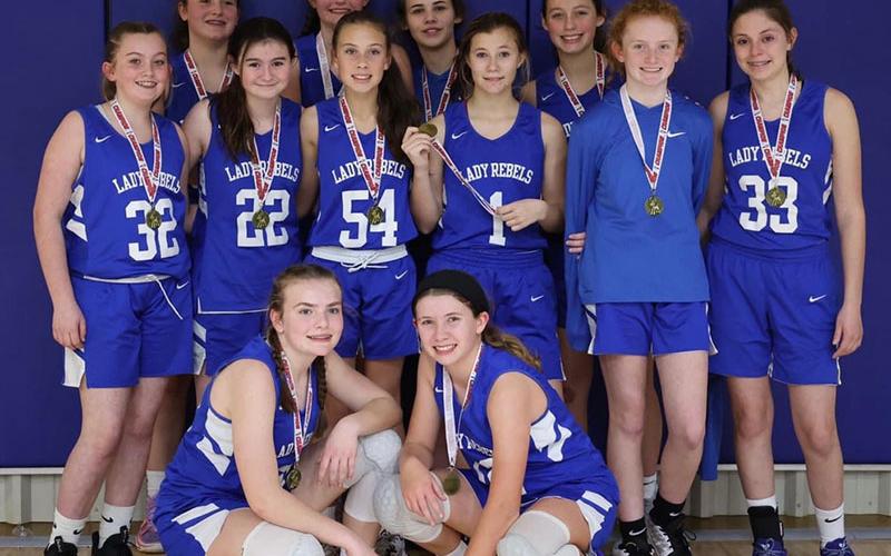 The Fannin County Middle School eighth grade Lady Rebels won the FCA Christmas Tournament by going undefeated. Shown following their title win are, from left, front,  Maggie Ledford and Izzie Jabaley; second row,  Elizabeth Powell, Kennedy Mason, Myla Rogers, Halle Walton, Albany Cole, and Noley Nations; and, back, Bridgett Allen, Reese Lewis, Lexi Gravely and Avi Ethington. Not pictured are Head Coach Tasha Anderson and Assistant Coach Morgan Helton.