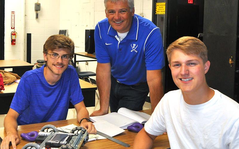 Fannin County High School teacher Bubba Gibbs, middle, is shown with two of his students, James Kyle, left, and Bryce Ware, earlier in the school year.