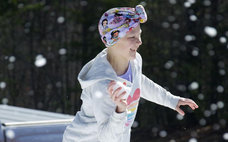Aubrey Hutson pulls her hand back, loaded with a snow ball, to throw at her sister at their donated cabin in Copperhill Friday, January 14.