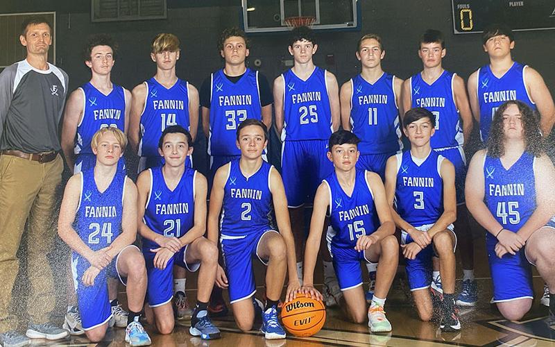 The Fannin County Middle School eighth grade Rebels, shown here in their team photo, won the Mountain Athletic Conference tourney title with a 60-37 defeat of Clear Creek. Shown, left to right, front are, Tyler Blake, Heath Bradburn, Jordan Richerson, Miller Denton, Matthew Ponton, Jacob Green; and,  back row, Coach Jeff Daves, Conner Kyle, Judah Wood, Cade Dockrey, Brody Henson, Brody Angel, Hudson York, and Holden Eavenson.