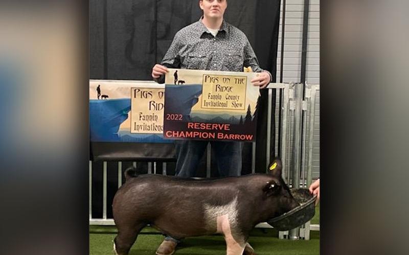 Shown is Slade Epperson, senior at Fannin County High School, with the hog he showed in the market hog show.