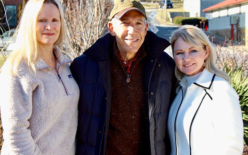 Blue Ridge Councilwoman Angie Arp, left, and Blue Ridge Mayor Rhonda Haight, right, stand with Daffodil Garden facilitator and spokesman Mike Weinroth, Sunday, January 30, at the reintroduction ceremony for the Daffodil Garden Memorial in downtown Blue Ridge.