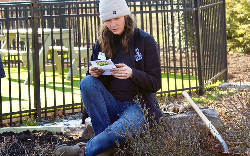 Fannin and Gilmer County Extension Agent Ashley Hoppers takes a moment to read about a child who perished during the Holocaust. Everyone who attended the re-introduction ceremony of the Daffodil Garden Memorial Sunday, January 30, was given a program with a biography and picture of a child who was murdered during the Holocaust and a daffodil bulb to plant in their memory.