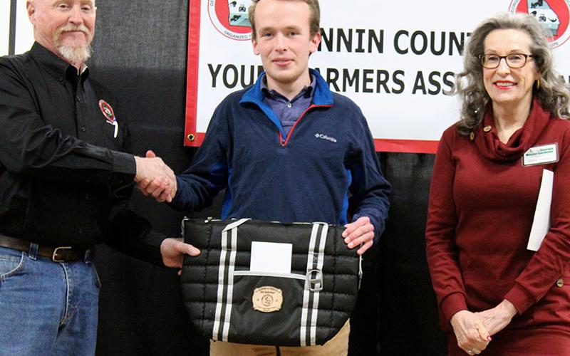 Nick Wollschlager, middle, was presented with the Beginning Agriculture Producer for 2021 award sponsored by The North Georgia Master Gardeners at the Fannin County Young Farmers Association (FCYFA) Awards Banquet Friday, February 4. He is shown with FCYFA President Kenny Queen and North Georgia Master Gardener Marie Traylor.