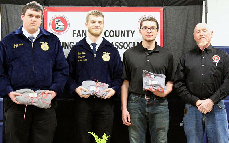 Shown are, from left, Fannin County High School seniors, Kaleb Couch, Evan Fish and Noah Hess being recognized as valuable assets to the future of agriculture and the Fannin County Young Farmers Association (FCYFA) at the fifth annual FCYFA Awards Banquet February 4. They are shown with FCYFA President Kenny Queen.