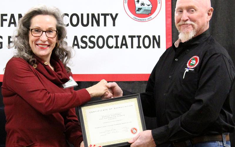 Marie Traylor accepts an award on behalf of The North Georgia Master Gardeners from FCYFA President Kenny Queen.