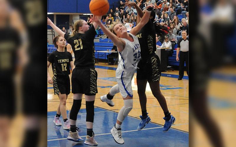 Reagan York fights for every rebound, winning the majority of the battles in the state tournament games against Temple and Washington County.