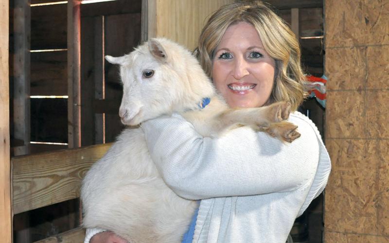 Jennifer Criteser is shown holding Bella Luna, one of many baby goats on the rescue farm she started after realizing how many animals need a good home.