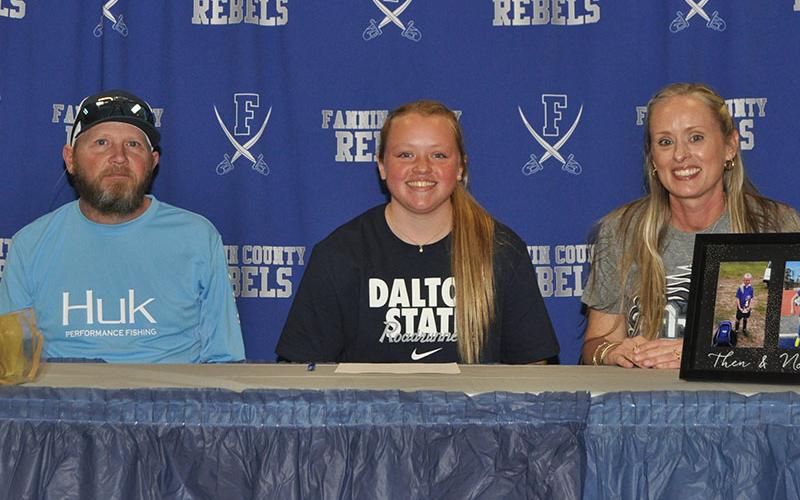 Fannin County High School women’s soccer player Mazie Goble smiles next to her father, Shannon Goble, and mother, Kristy Kouns, after signing her letter of intent to play soccer at Dalton State College.