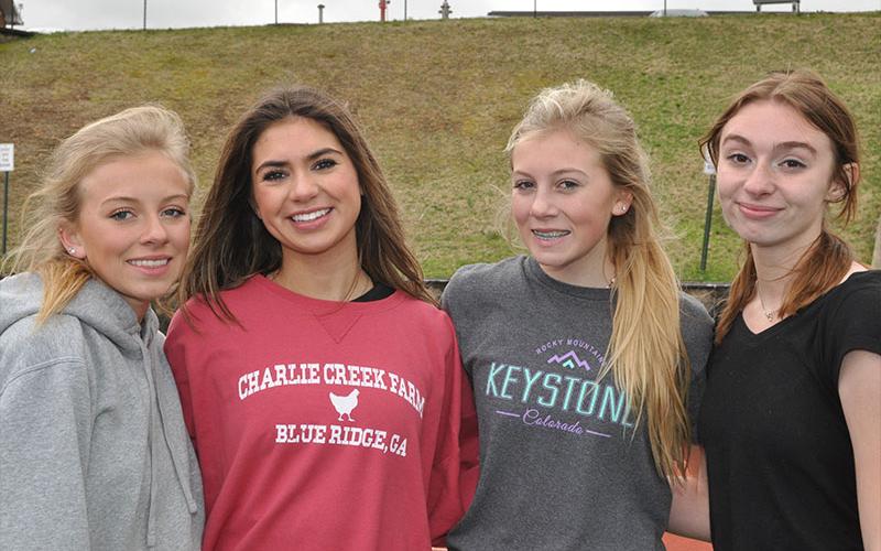 Shown, from left, are Carlee Holloway, Monica Cosentino, Lindsey Holloway and Caylee Gaddis just after running a timed 4x800 at practice March 9.