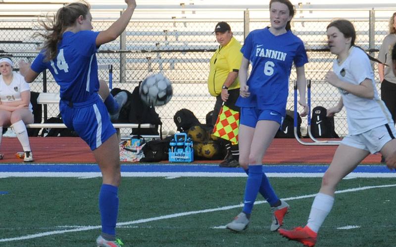 Kinsley Sullivan (14) and Hannah McSwain are shown in action for the Lady Rebels.