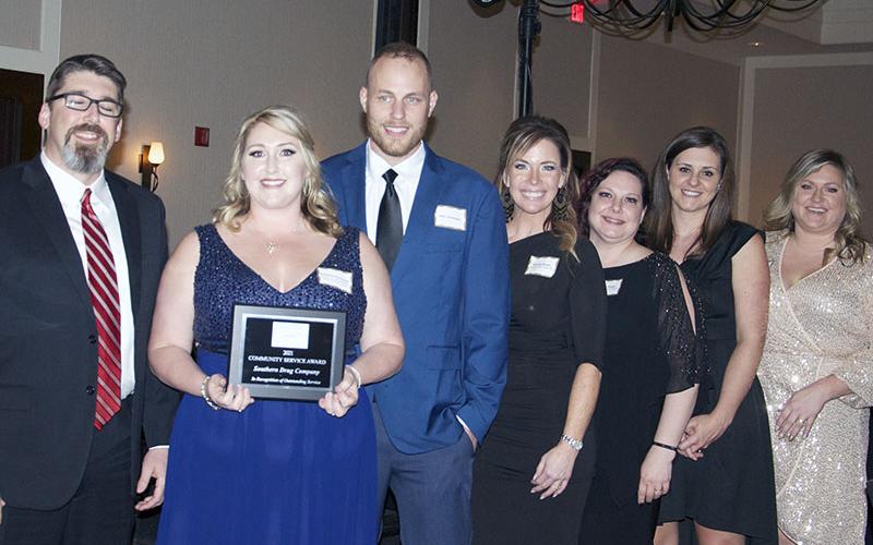 Incoming chamber board of directors Chairman Jason Jones, left, is shown presenting the Community Service Award to, from left, owner of the Southern Drug Company Suzanne Stepp Davenport with her husband John Davenport, and Southern Drug employees Amanda Moore, Cheryl Stepp, Sarah Pruitt and Amanda Rogers.