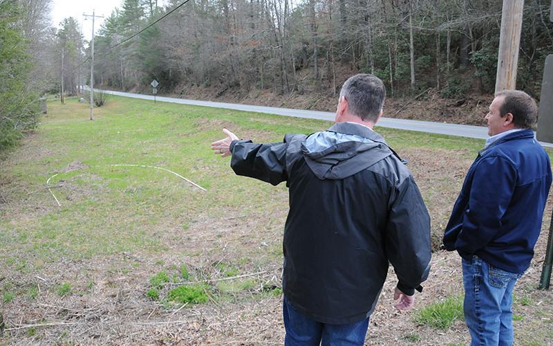 Fannin County Commission Chairman Jamie Hensley, left, and Public Works Director Zack Ratcliff look over the area upstream and adjacent to Shallowford Bridge that will be turned into parking and provide river access. Work to prepare the parking area will be completed by county crews while a local Boy Scout will be building steps to access the Toccoa River for his Eagle project.