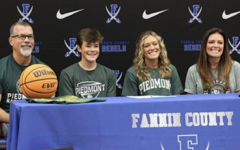 Reagan York, second from right, is all smiles after signing her letter of intent to play college basketball at Piedmont University. The signing ceremony took place Sunday, April 24, in the Fannin County High School gym. York is shown with from left, her father, Richard York, her brother, Hudson York, and her mother, Shannon York.