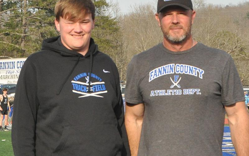 Senior Dylan Collins, left, was escorted by Throwing Coach Jeff Kuna.