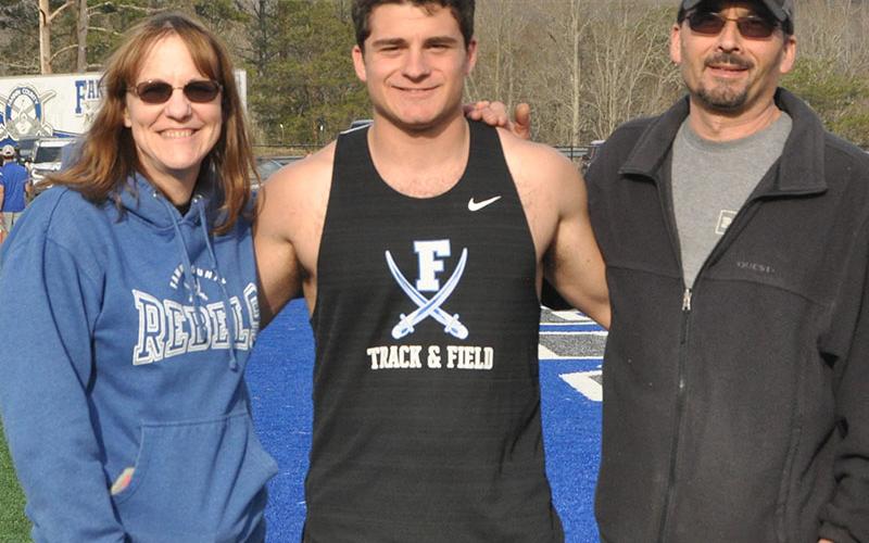 Senior Chris Gaitanoglou, middle, was escorted by his mother Molly Gaitanoglou and his father Pete Gaitanoglou.