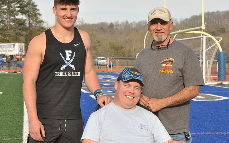 Senior Seth Reece, left, was escorted by his brother Zach Reece, middle, and father Greg Reece.
