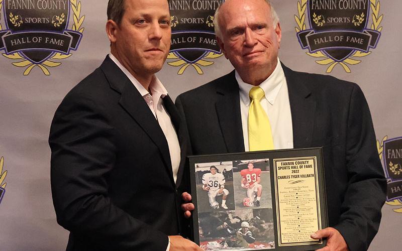 Inductee Charles Tyger Vollrath, left, receives his plaque from Fannin County Sports Hall of Fame President Mike Harper, right.