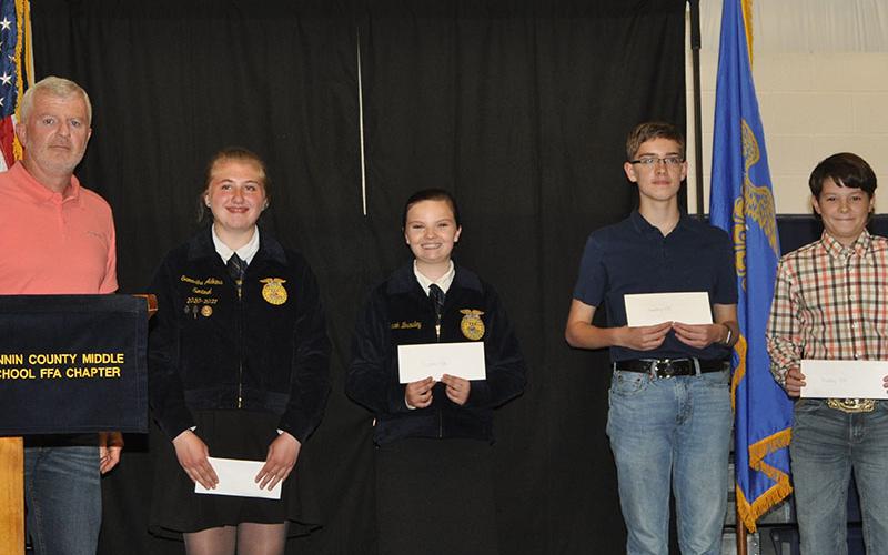 Darrel Davis, from left, presented FFA middle school honors to Samantha Adkins, Sarah Brawley, James Burrell and Mason Ramey.