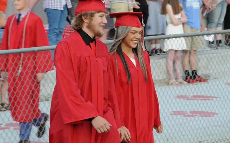 Eli White and Sydney Hickey are all smiles as they enter the Copper Basin High School graduation ceremony.