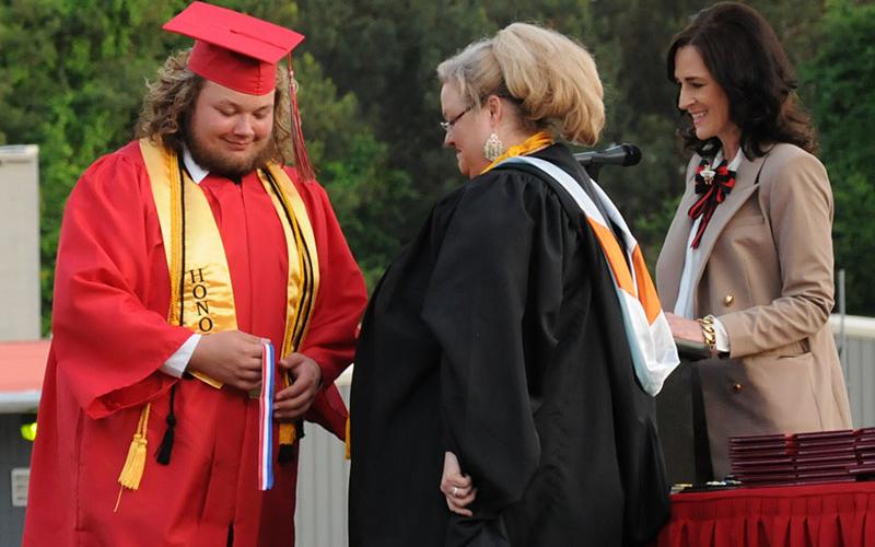 Brock Whitaker receives his Honor Cord from Amber Daly as Copper Basin High School Principal Holly Smith looks on.