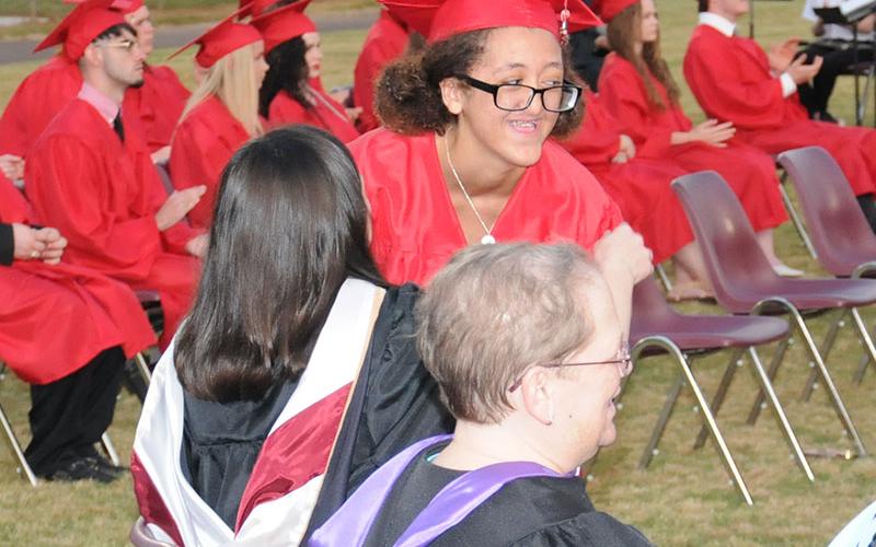 Aiden Garcia gets a hug from a teacher after receiving her Copper Basin High School diploma.