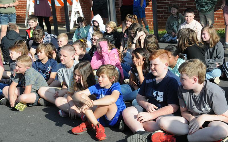 East Fannin students learned about dairy farming in Georgia when Nicole Duvall with Georgia’s Mobile Dairy Classroom visited the school last week. Shown along the first, staggered row, are, from left, Brody Golden, Brax Newton, Cash Rittenberry, Jacob Green, Allison Cantrell, Adam King, Maddox Newman and Aric Carder.