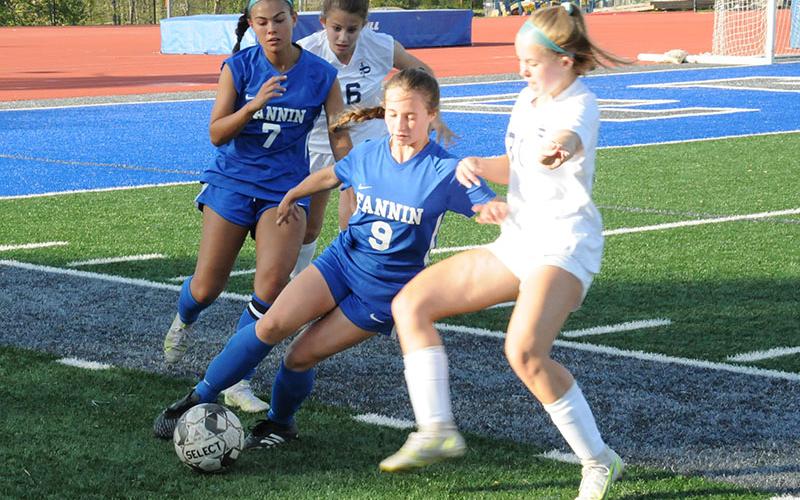 Fannin County’s Karmah Eaton (9) moves the ball against a Pace defender in the Lady Rebels state playoff match April 25. Taylor Poland (7), who had four steals in the match, follows the play.