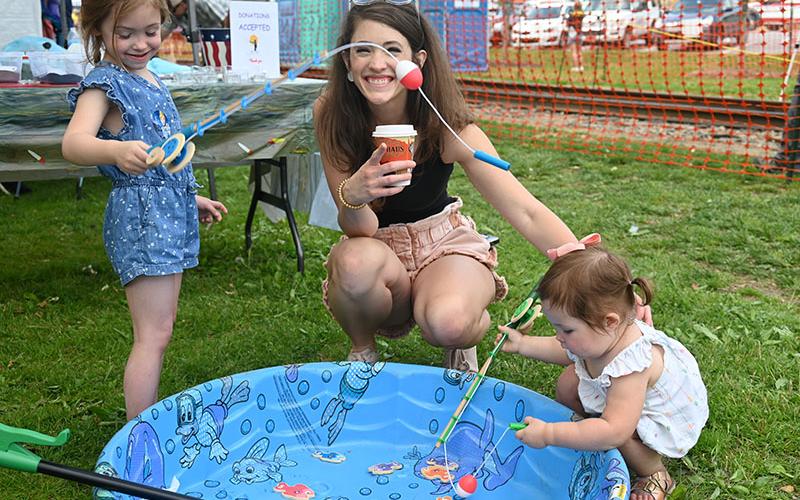 Madeleine Coddou, left, and sister, Georgia, learned about fishing and the importance of keeping our rivers trash free at the Faith Presbyterian Church, of Blue Ridge, booth during the 2022 Blue Ridge Trout and Outdoor Adventures Festival Saturday, April 30. They are shown with their mother, Jennifer.
