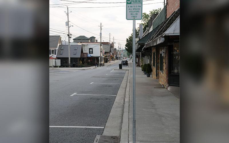 Blue Ridge Assistant Police Chief R.A. Stuart writes a citation for a car that has exceeded the three-hour parking limit in downtown Blue Ridge. The areas where the limit is being enforced are clearly market along East Main Street from Church to Mountain streets and along West Main Street from Mountain to Depot streets.
