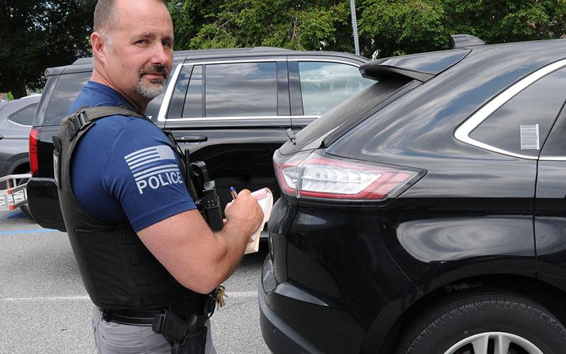 Blue Ridge Assistant Police Chief R.A. Stuart writes a citation for a car that has exceeded the three-hour parking limit in downtown Blue Ridge. The areas where the limit is being enforced are clearly market along East Main Street from Church to Mountain streets and along West Main Street from Mountain to Depot streets.