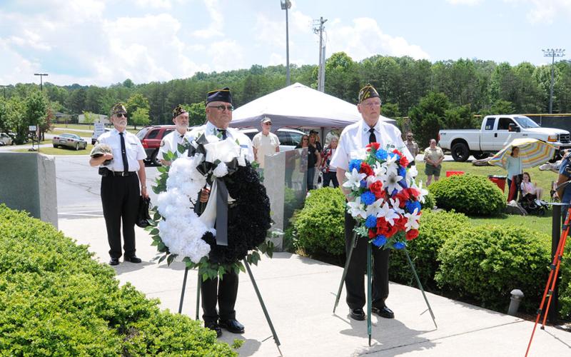 The Memorial Day ceremony at Veterans Memorial Park honored those who have given the supreme sacrifice in the name of freedom. Veterans preparing for a portion of the event are, from left, front, Richard Crosley and D.R. Horton, and, back, Nick Wimberley and Steve Strickland.