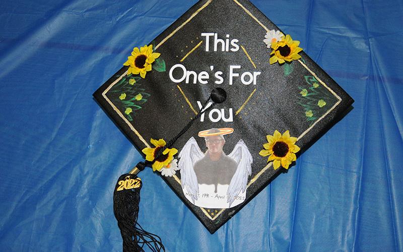 Macy Watkins adorned her GED graduation cap to honor her brother, Gage Dixon, who died unexpectedly at the age of 30. Watkins rested on the foundation of his memory the day she took, and passed, the final part of her GED test.